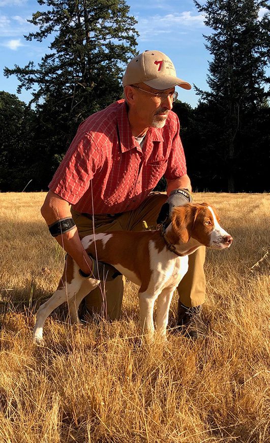 Dave Bale holding a white-brown dog